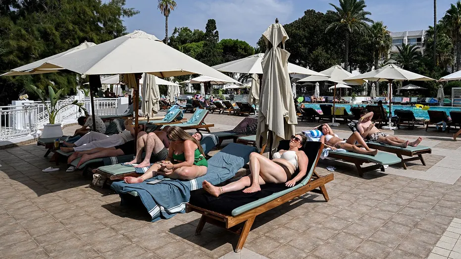 people-laying-pool-chairs